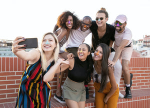 A group of friends taking a photo to show off their noses with Noz colorful Sunscreen Sticks. 