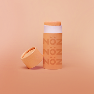 Cap off view of Noz Sunscreen Stick in orange